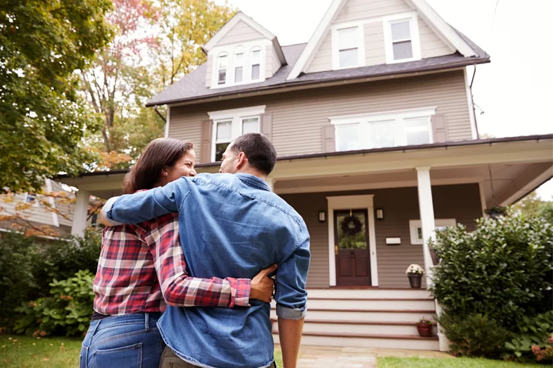 Couple walking into house